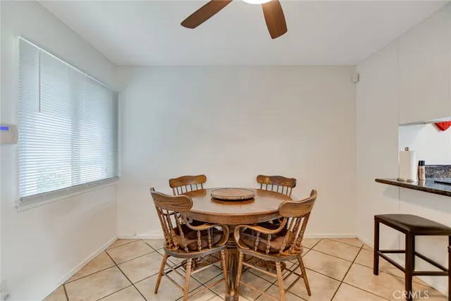 a view of a dining room with furniture and a chandelier fan