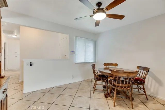 a kitchen with stainless steel appliances granite countertop a sink a stove a dining table and chairs