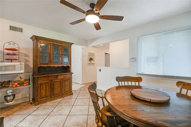 a kitchen with white cabinets and refrigerator