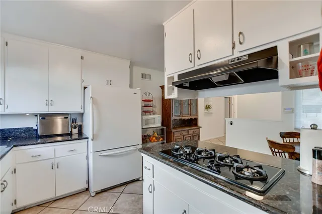 a kitchen with stainless steel appliances granite countertop a stove and a sink