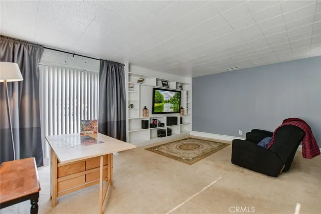 a living room with furniture window and a wooden floor