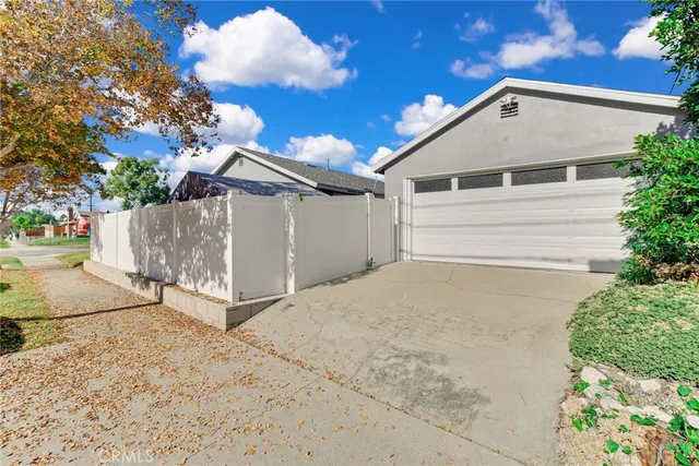 a view of a white house with a yard