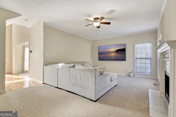 a kitchen with stainless steel appliances kitchen island granite countertop a stove a sink a dining table and chairs
