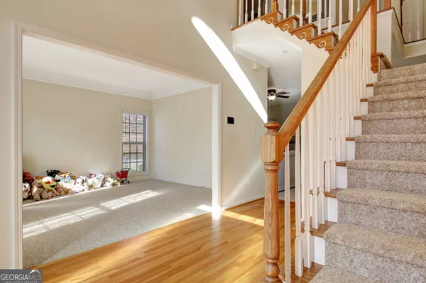 a view of entryway and hall with wooden floor