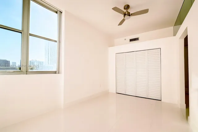 a view of a closet area with wooden floor