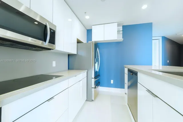 a kitchen that has a sink and a stove in it