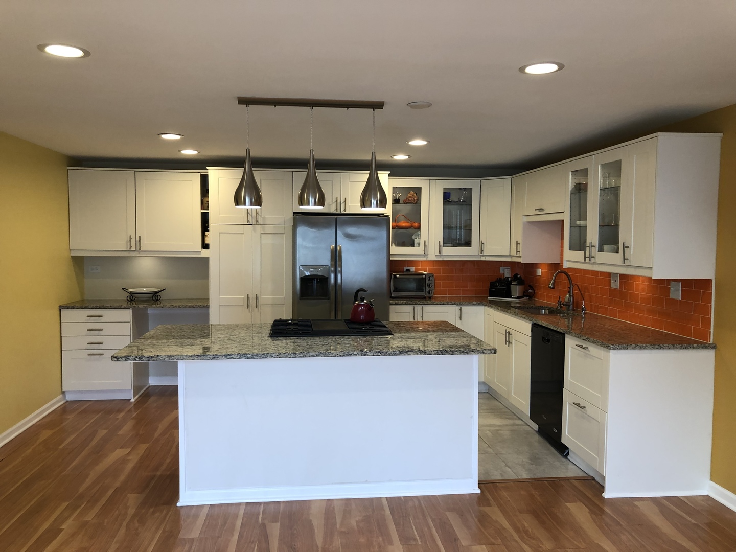 Undisclosed Address Schaumburg, IL 60193 - Photo 4 of 10 a kitchen with stainless steel appliances granite countertop wooden floors and view living room