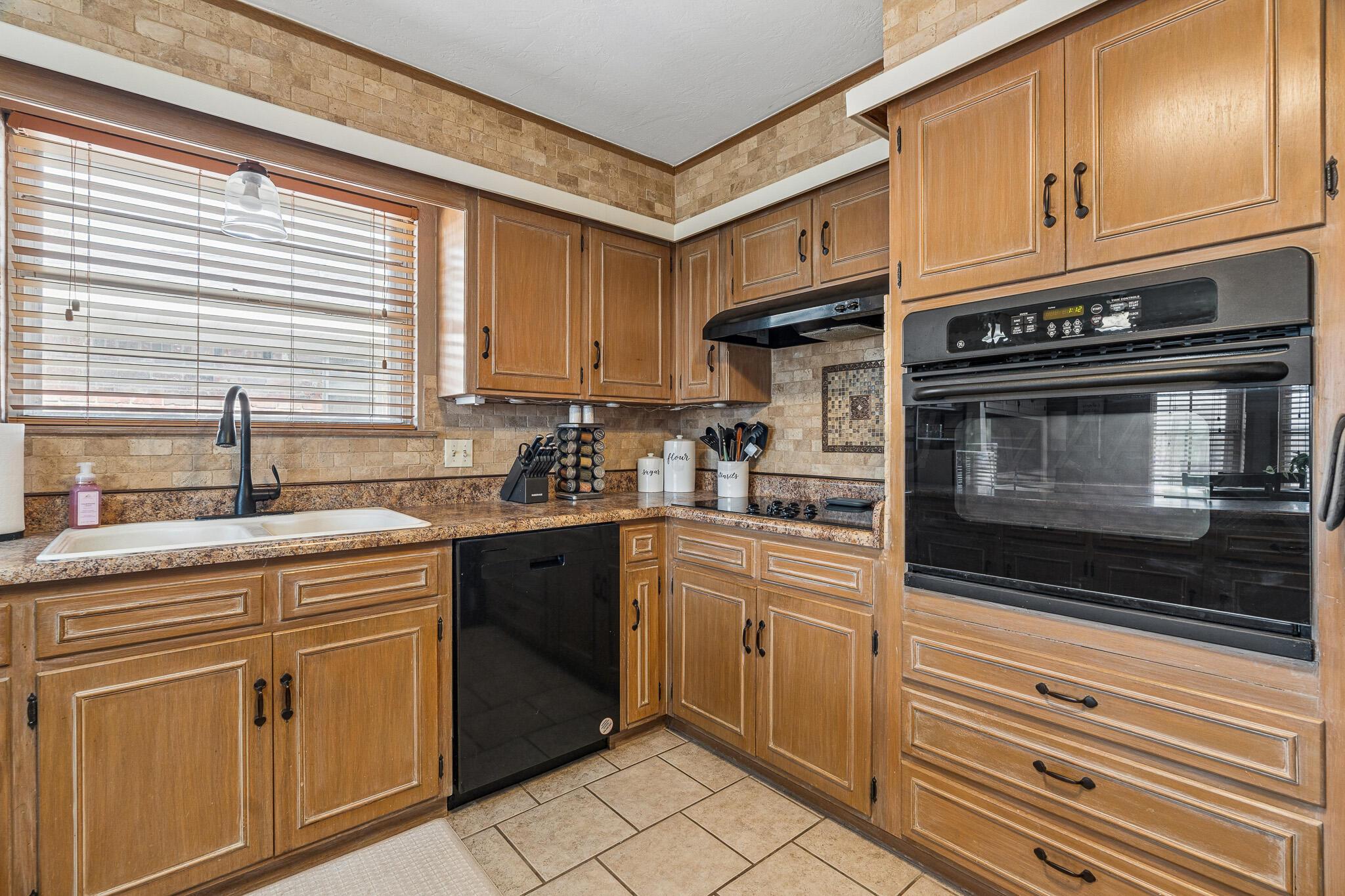 3424 Wayne Street Amarillo, TX 79109 - Photo 15 of 33 a kitchen with cabinets appliances and a sink