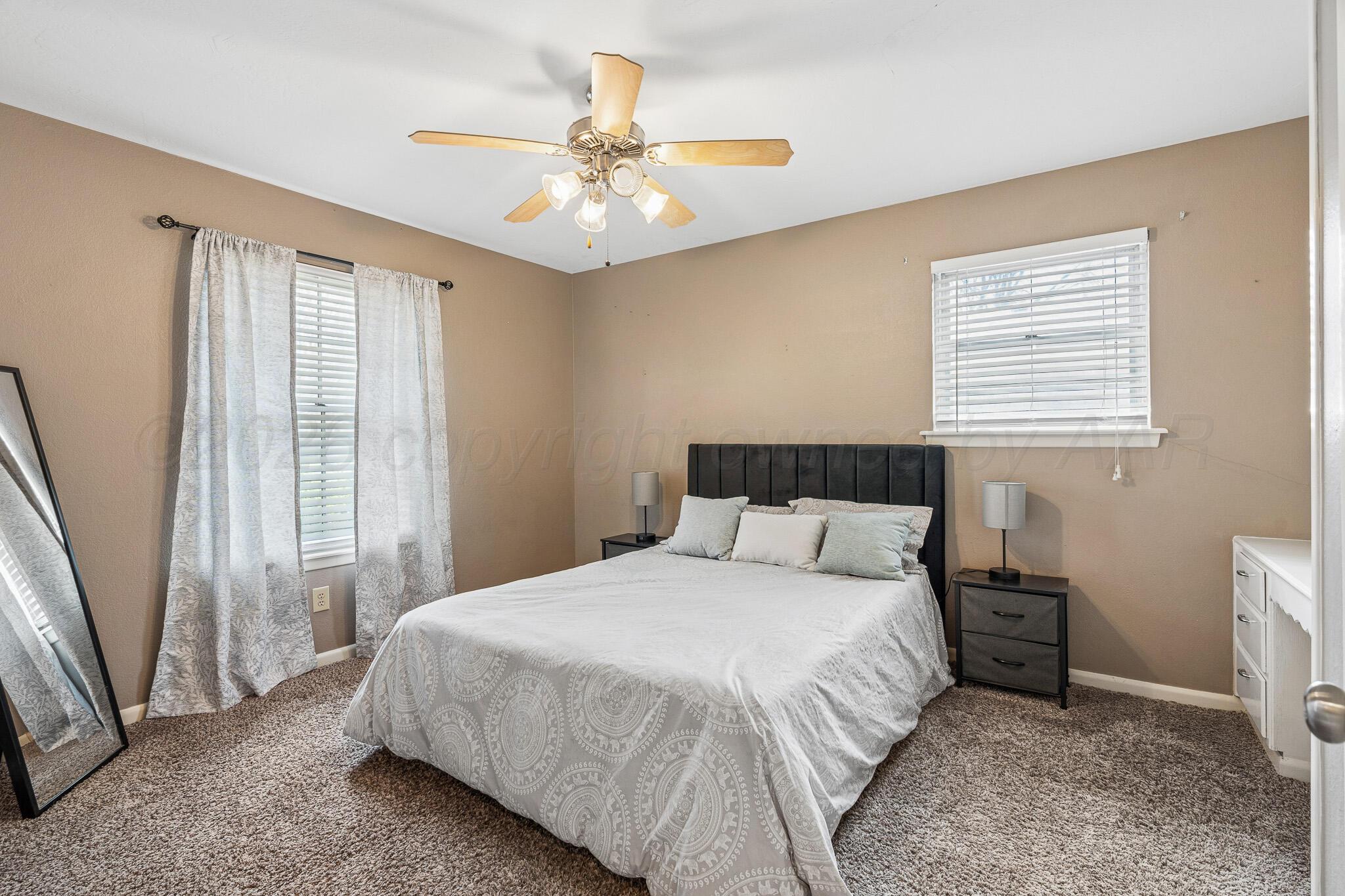 3424 Wayne Street Amarillo, TX 79109 - Photo 20 of 33 a bedroom with a large bed and a window