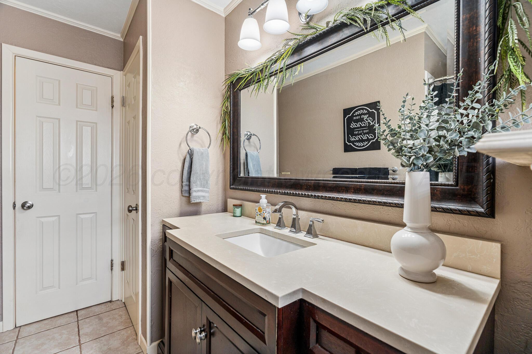 3424 Wayne Street Amarillo, TX 79109 - Photo 23 of 33 a bathroom with a sink and a mirror