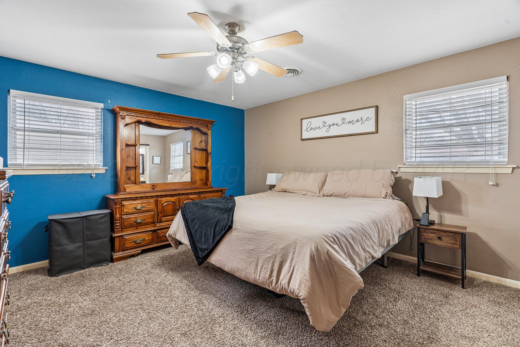 3424 Wayne Street Amarillo, TX 79109 - Photo 27 of 33 a bedroom with a bed dresser and wooden floor