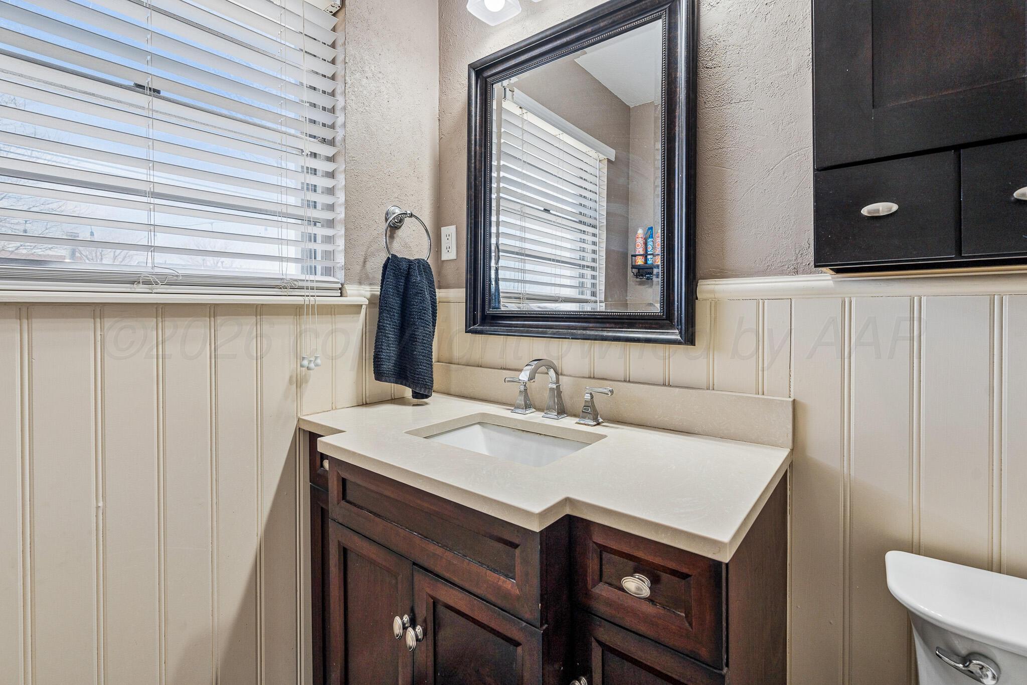 3424 Wayne Street Amarillo, TX 79109 - Photo 29 of 33 a bathroom with a sink a vanity and a mirror