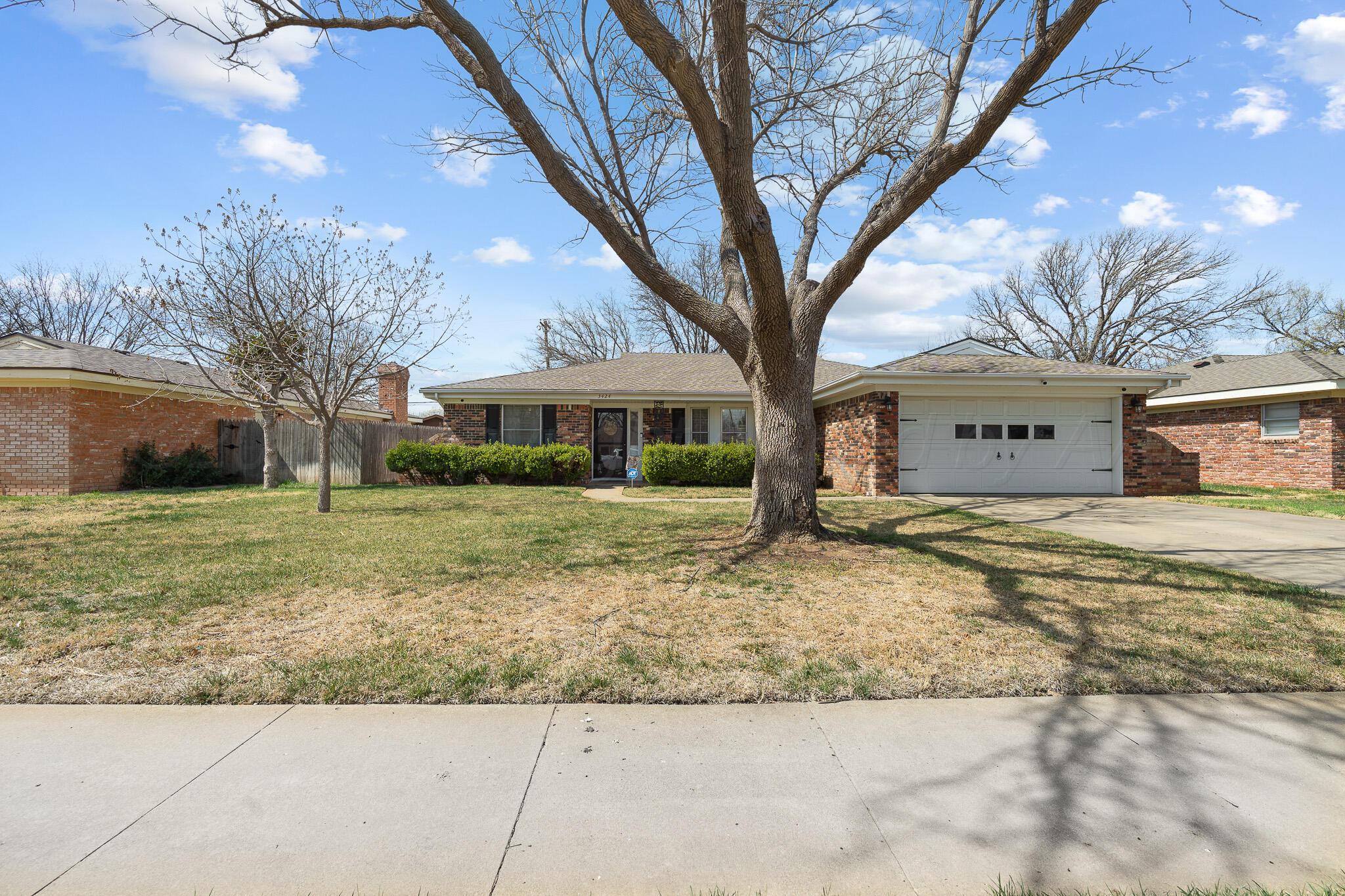 3424 Wayne Street Amarillo, TX 79109 - Photo 3 of 33 a large tree in front of a white house