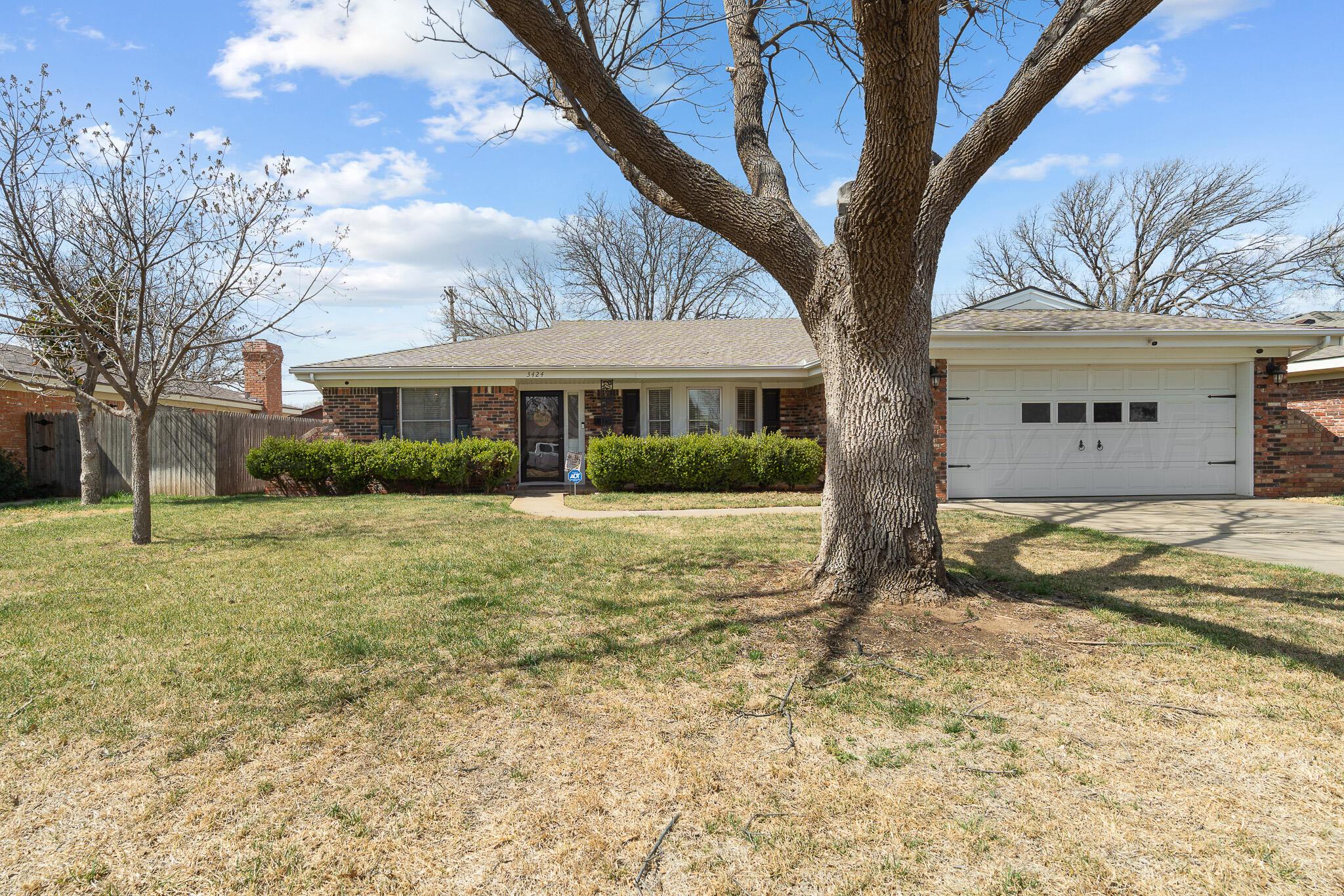 3424 Wayne Street Amarillo, TX 79109 - Photo 4 of 33 a front view of a house with a yard