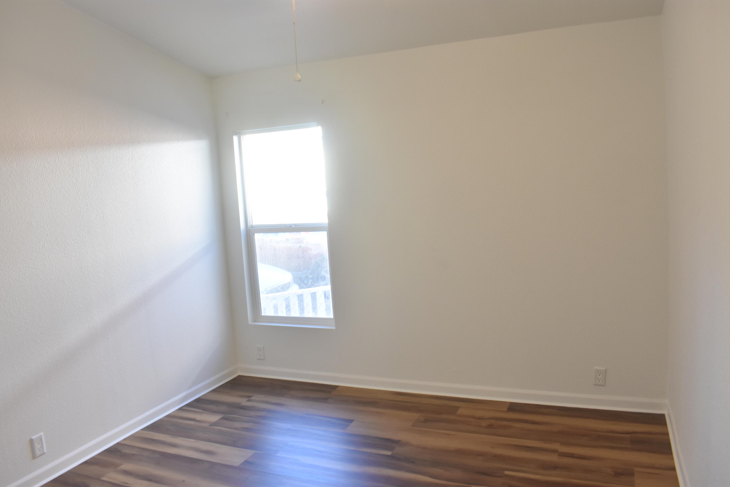 12125 Lake Boulevard Redding, CA 96003 - Photo 13 of 24 a view of an empty room with wooden floor and a window