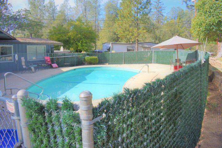 12125 Lake Boulevard Redding, CA 96003 - Photo 20 of 24 a front view of a house with a yard and a garden