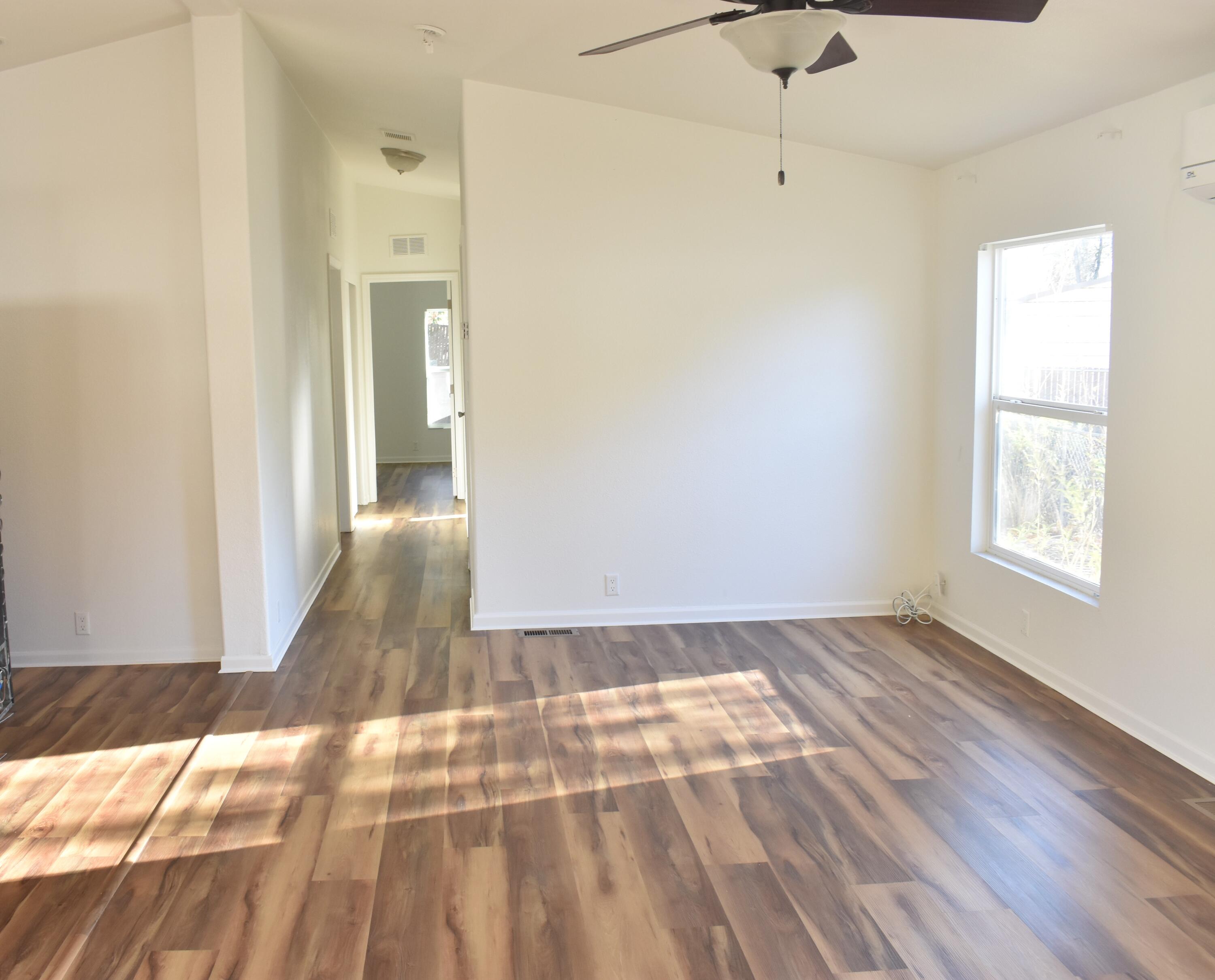 12125 Lake Boulevard Redding, CA 96003 - Photo 3 of 24 a view of an empty room with wooden floor and a window