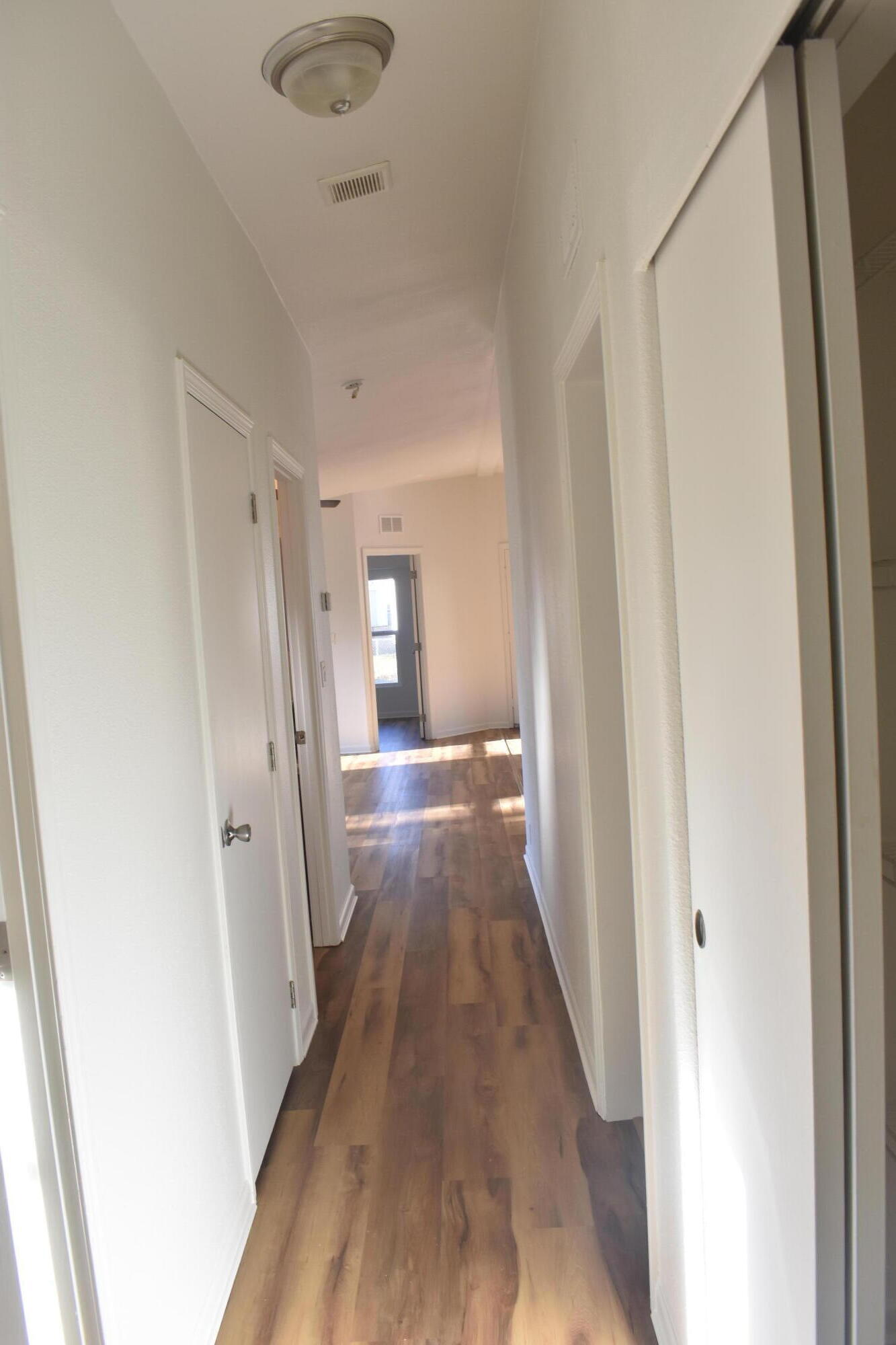 12125 Lake Boulevard Redding, CA 96003 - Photo 4 of 24 a view of a hallway with wooden floor and a bathroom