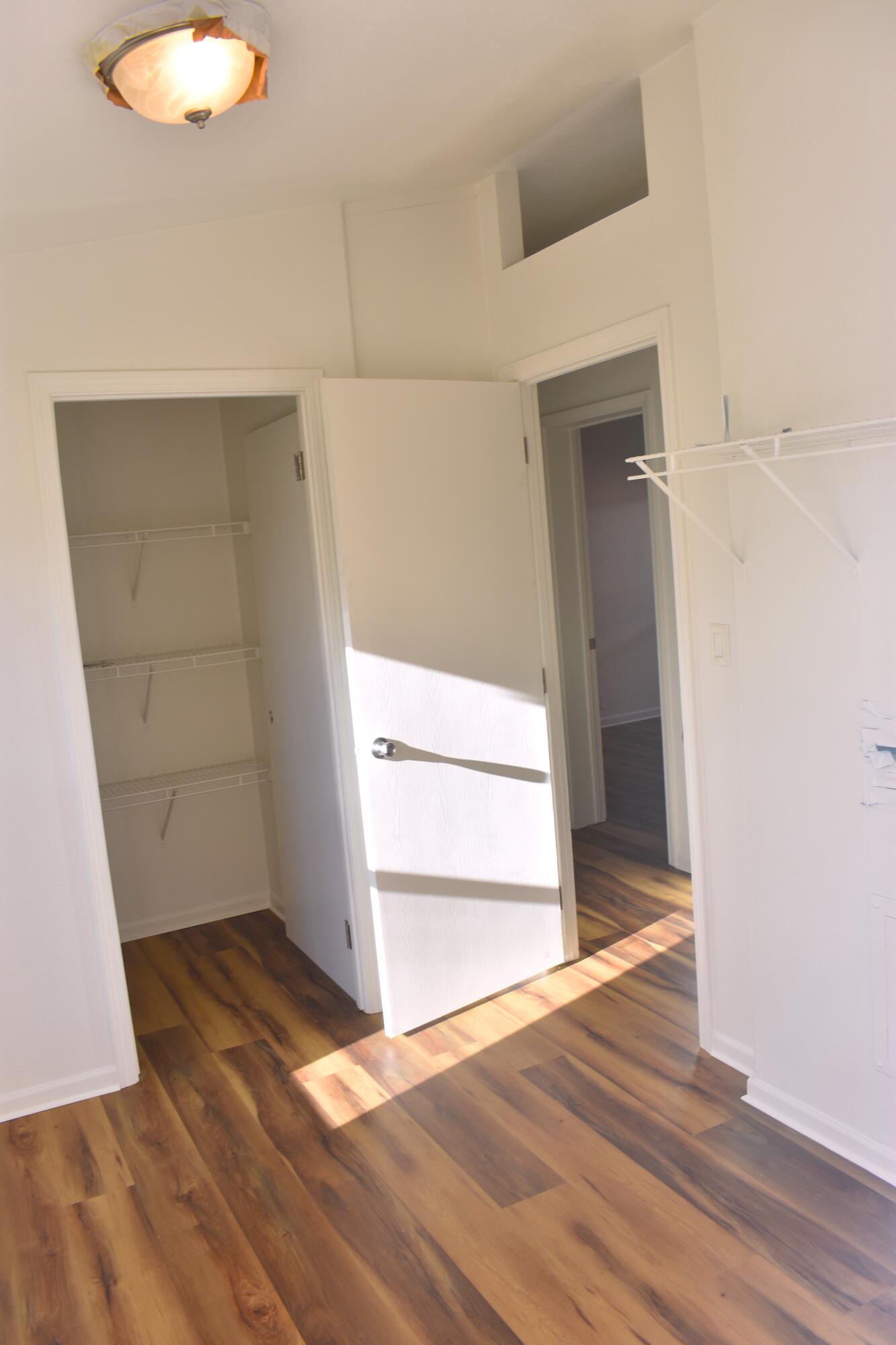 12125 Lake Boulevard Redding, CA 96003 - Photo 5 of 24 an empty room with wooden floor and windows