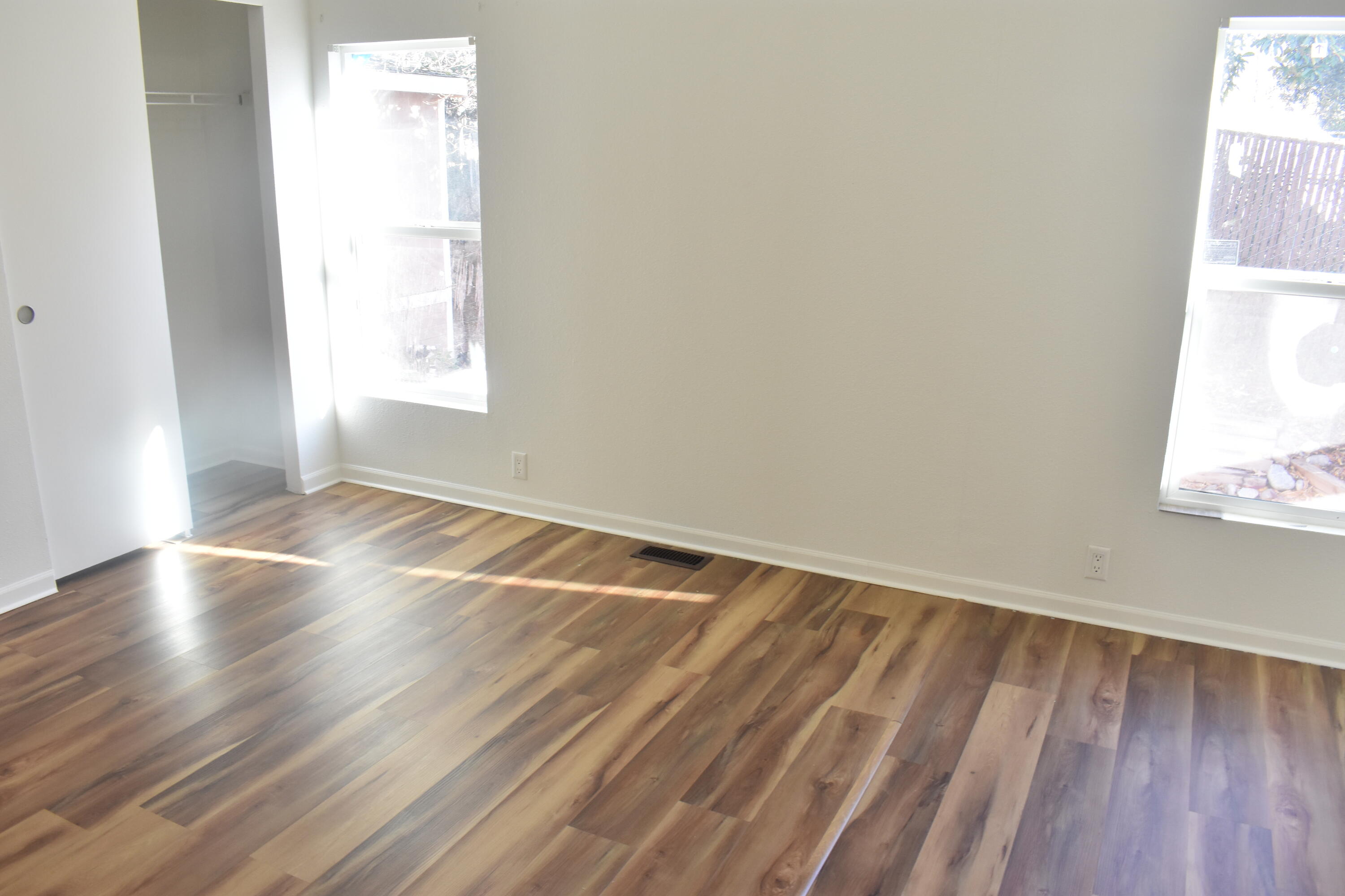 12125 Lake Boulevard Redding, CA 96003 - Photo 6 of 24 an empty room with wooden floor and windows