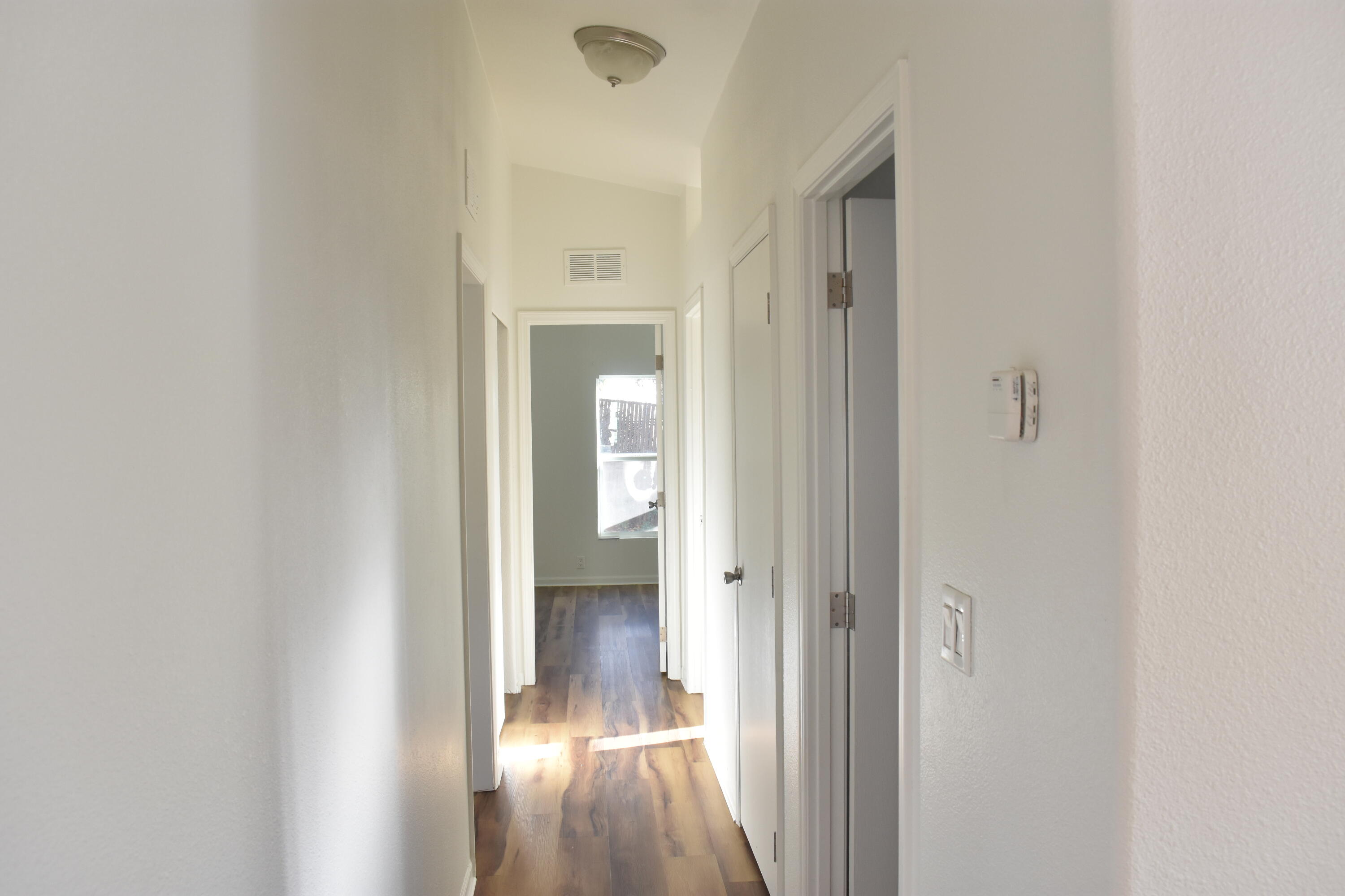 12125 Lake Boulevard Redding, CA 96003 - Photo 10 of 24 a view of a hallway with wooden floor and a bathroom