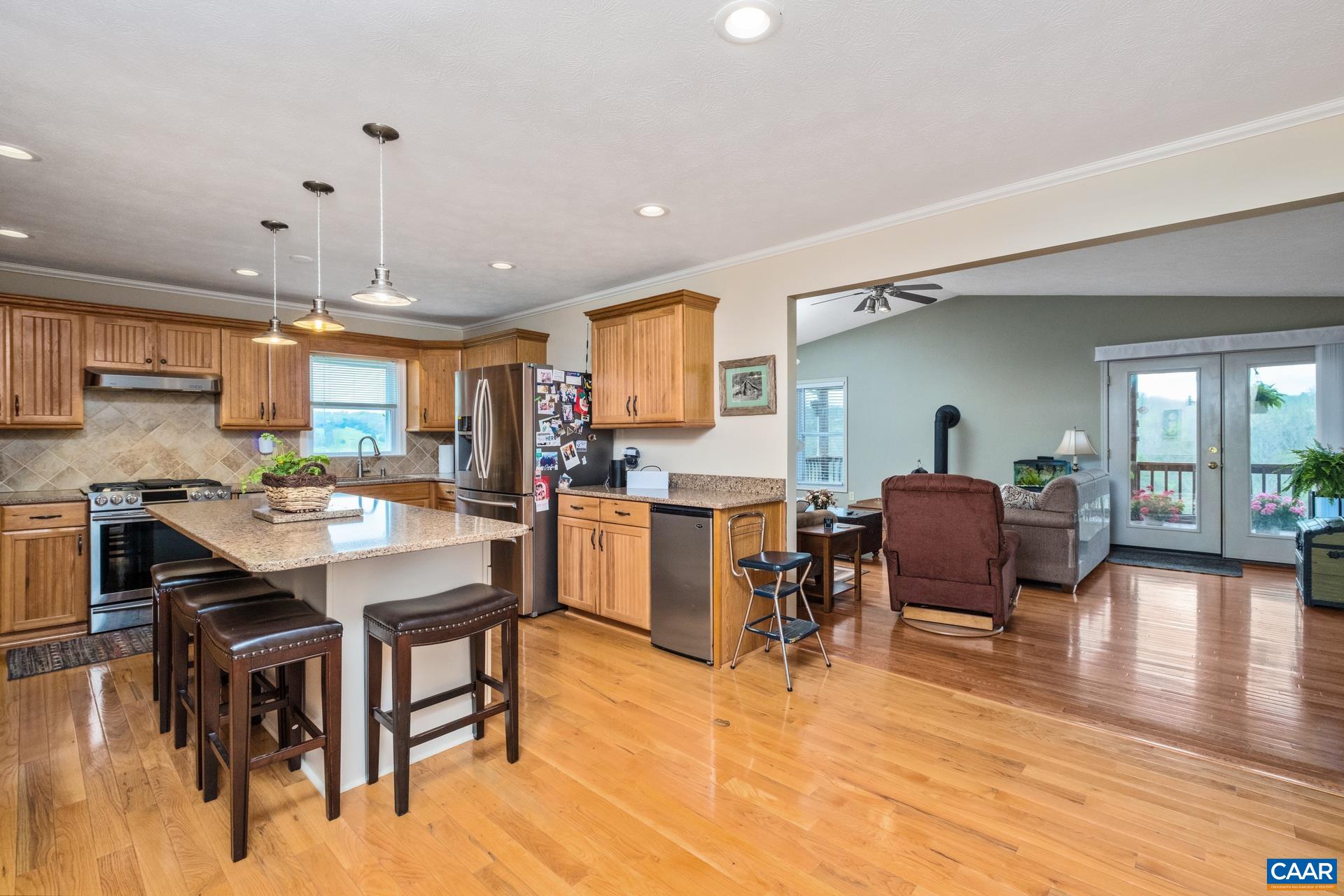 349 Todd Road Mount Sidney, VA 24467 - Photo 13 of 43 a kitchen with a table chairs refrigerator and cabinets