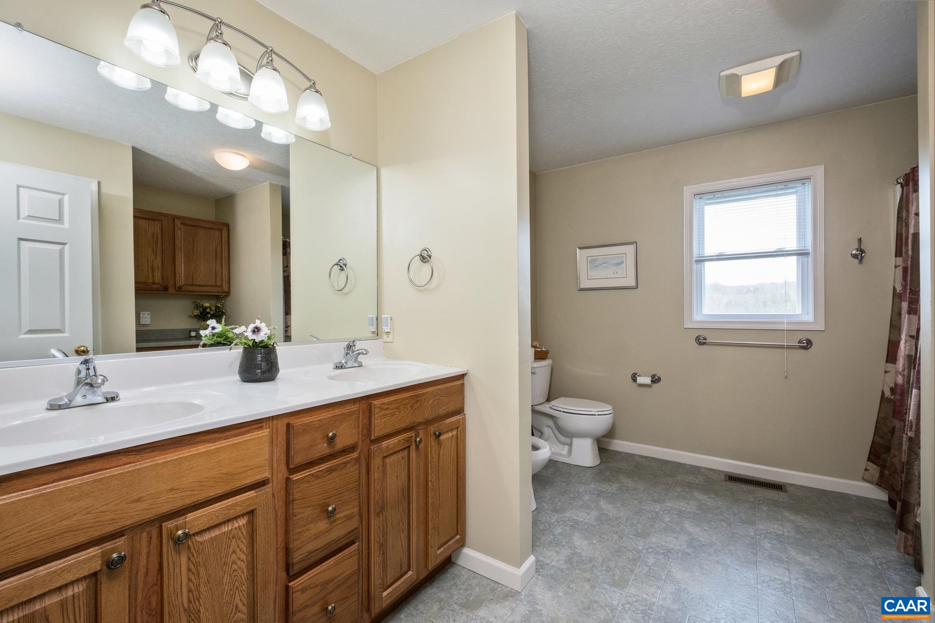 349 Todd Road Mount Sidney, VA 24467 - Photo 19 of 43 a bathroom with a granite countertop sink a toilet and a mirror