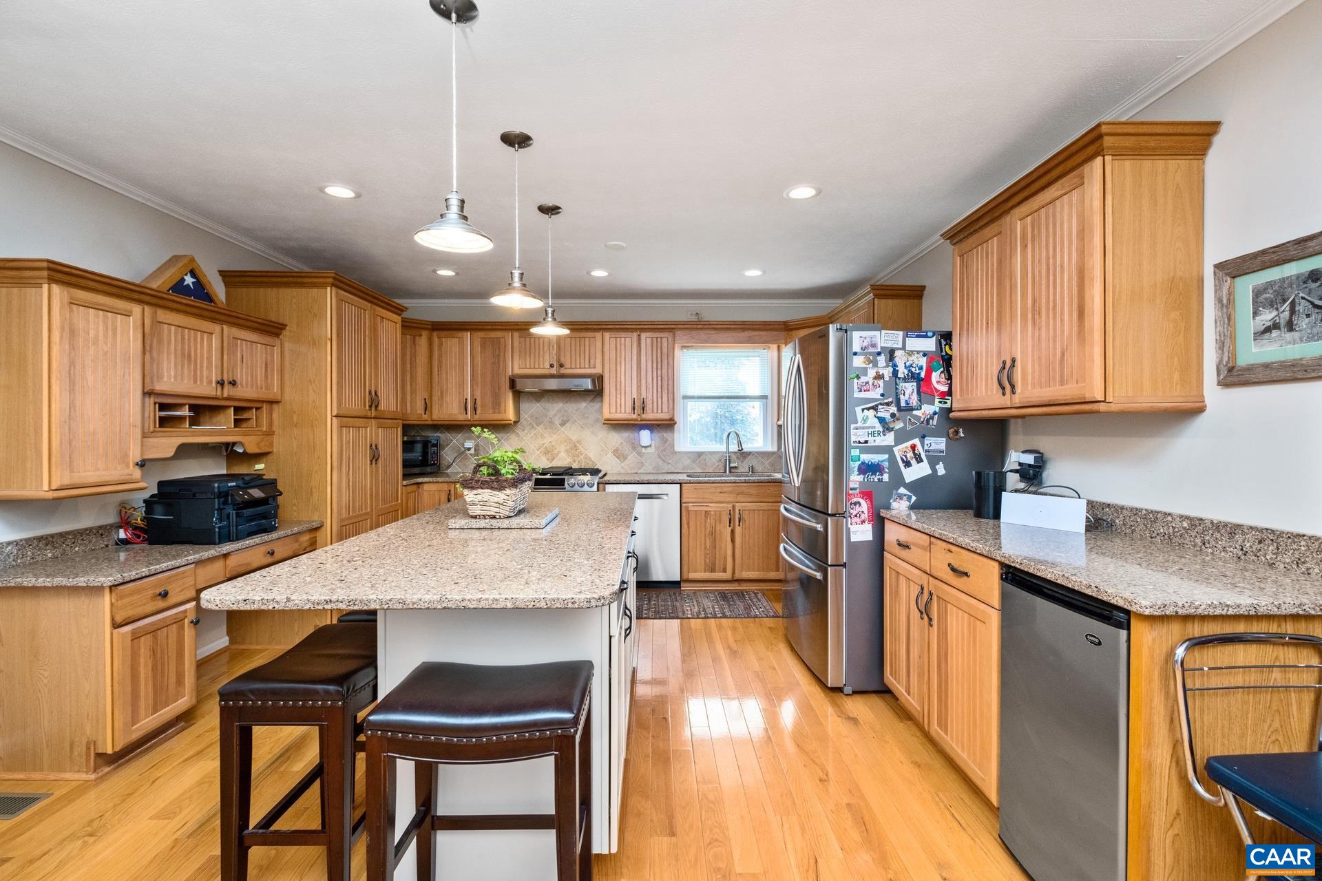 349 Todd Road Mount Sidney, VA 24467 - Photo 9 of 43 a kitchen with stainless steel appliances granite countertop a refrigerator a sink dishwasher a stove and white countertops with wooden floor