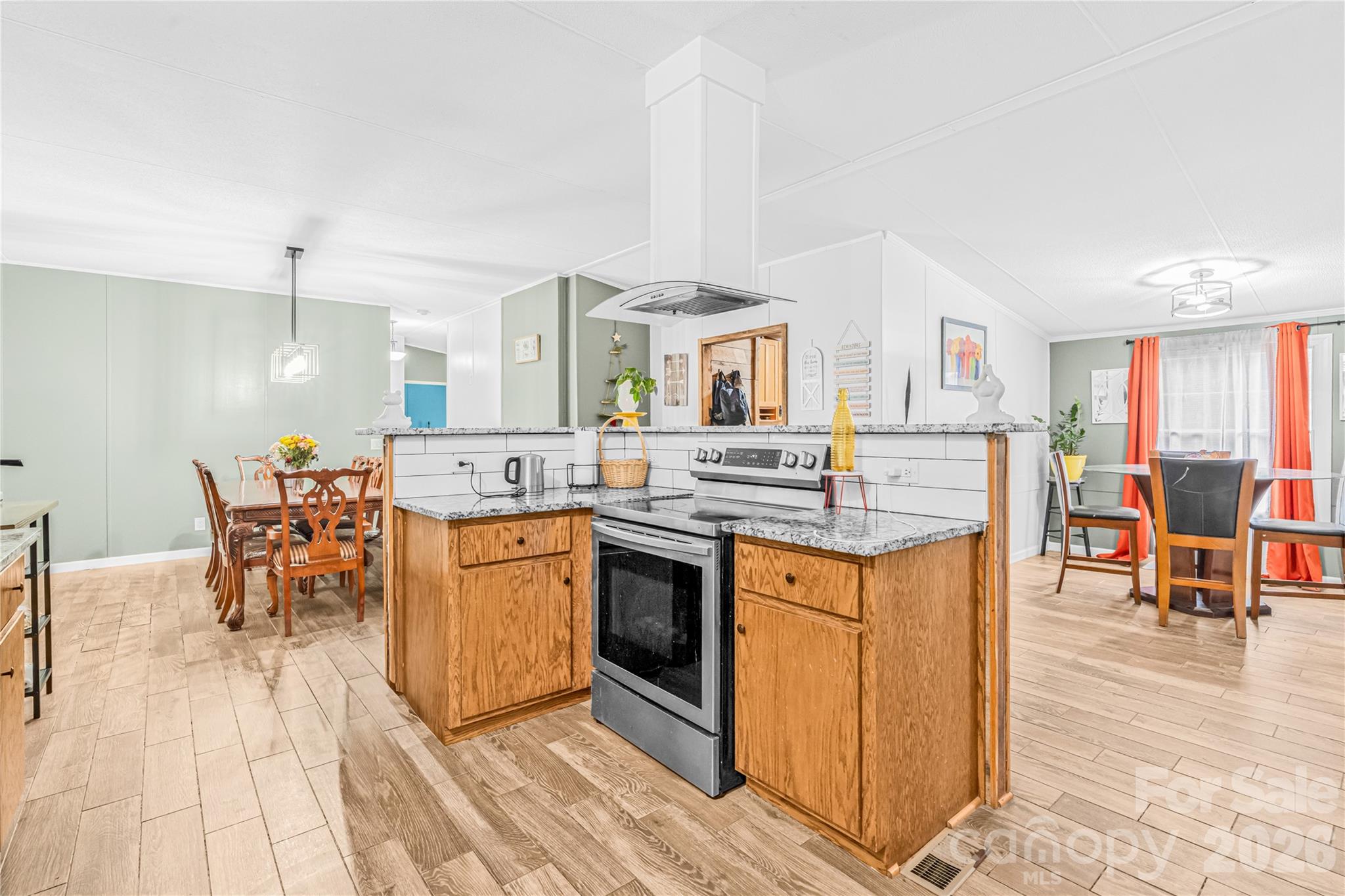 2235 Sandy Ridge Church Road Morven, NC 28119 - Photo 14 of 38 a kitchen with stainless steel appliances granite countertop a stove top oven a sink a dining table and chairs