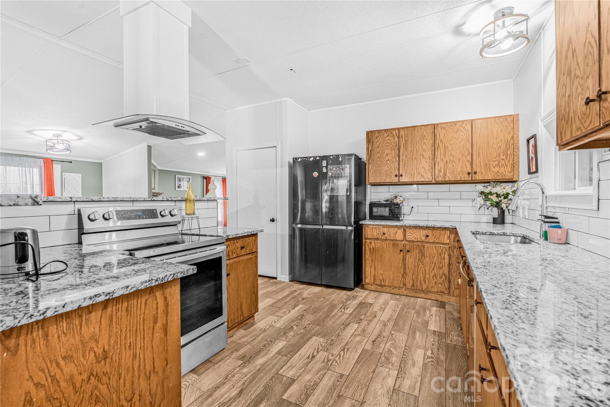 2235 Sandy Ridge Church Road Morven, NC 28119 - Photo 15 of 38 a kitchen with stainless steel appliances granite countertop a sink stove and refrigerator