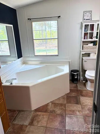 a bathroom with a bathtub and toilet
