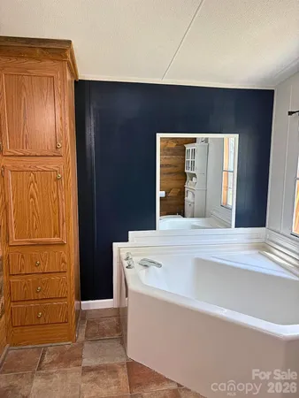 a view of kitchen with granite countertop cabinets and refrigerator
