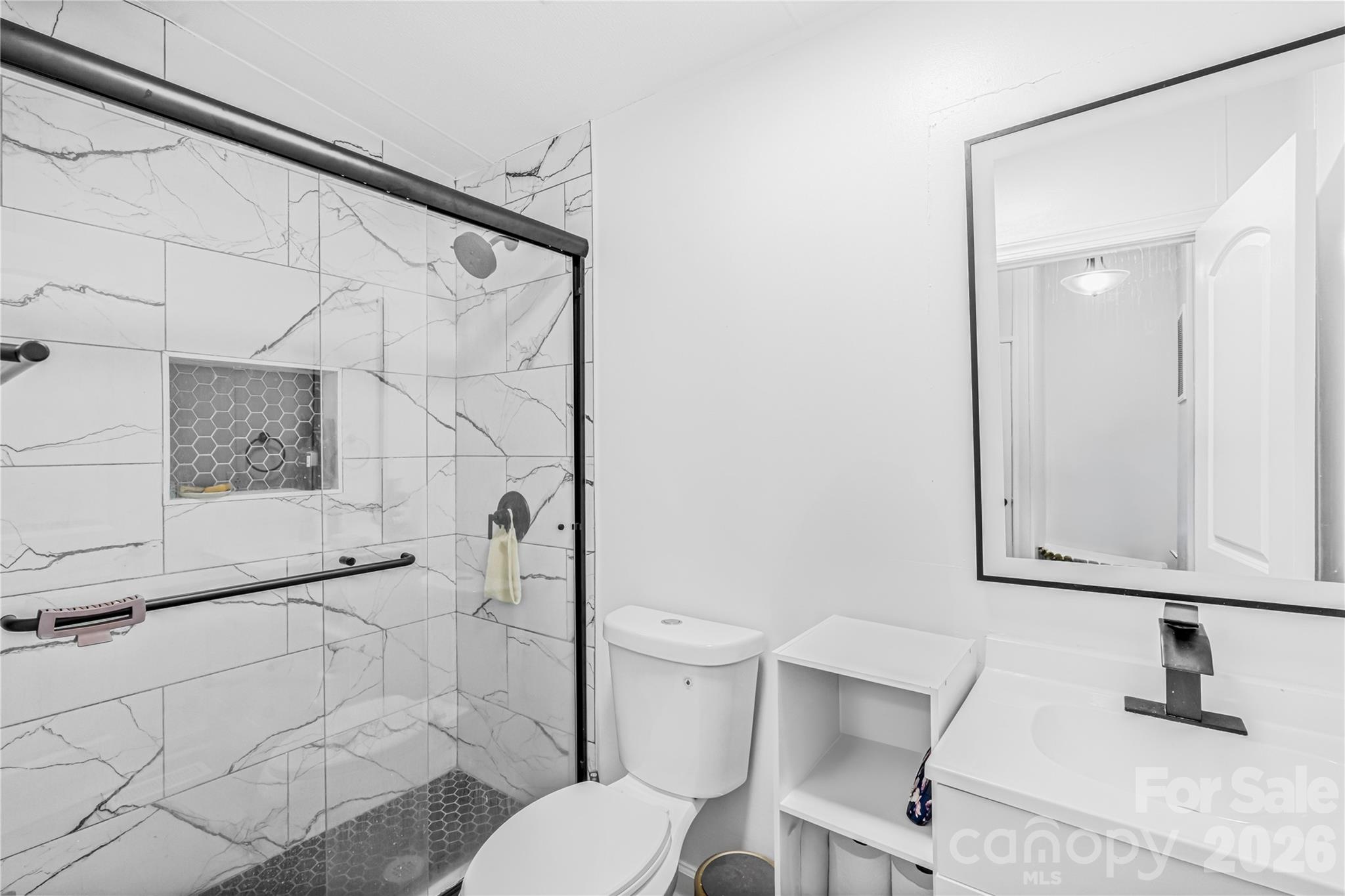 2235 Sandy Ridge Church Road Morven, NC 28119 - Photo 30 of 38 a bathroom with a toilet sink and shower