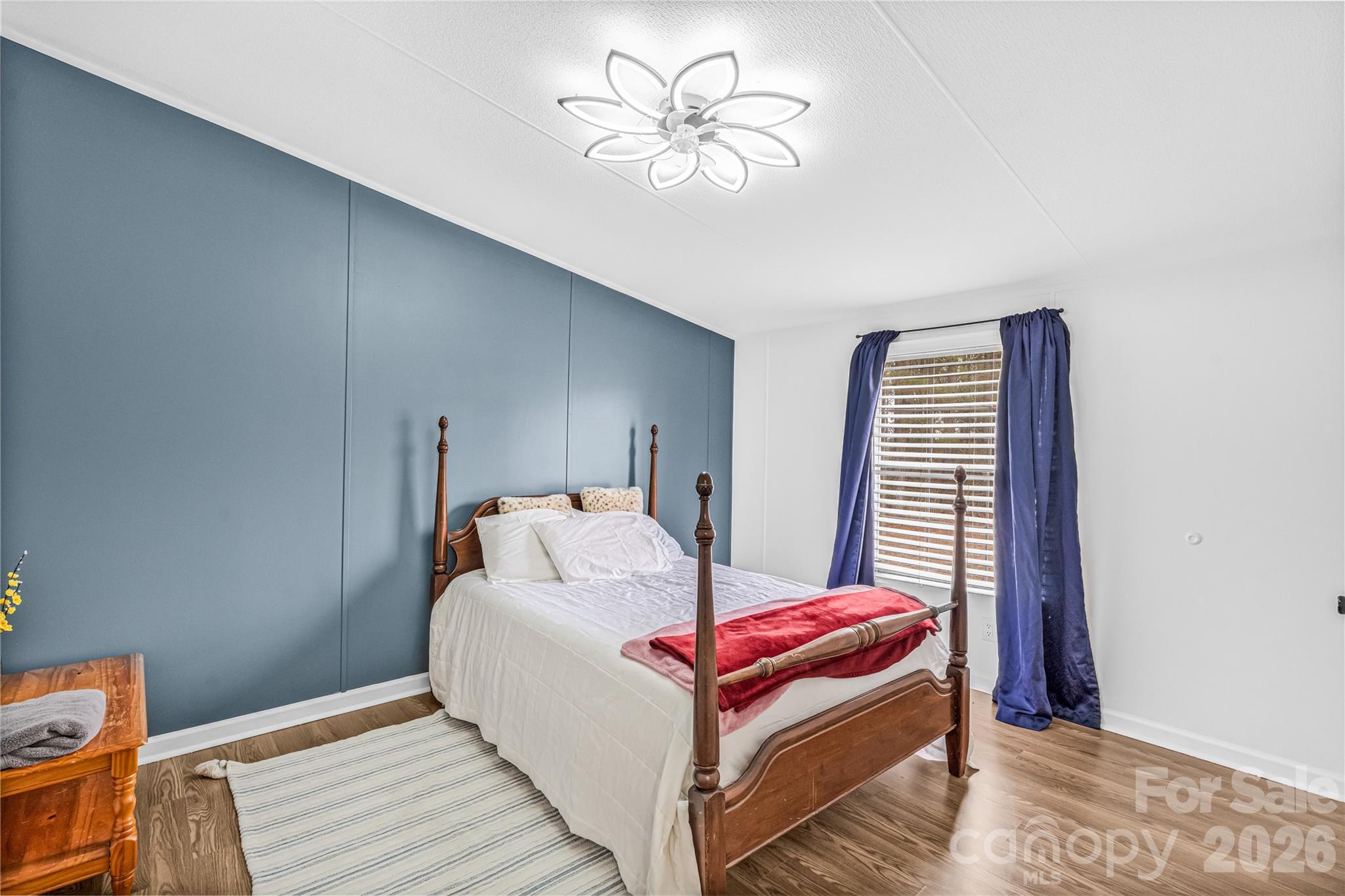 2235 Sandy Ridge Church Road Morven, NC 28119 - Photo 31 of 38 a bedroom with furniture and a chandelier