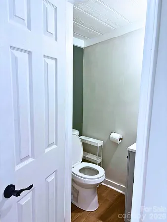 a white toilet sitting next to a small sink