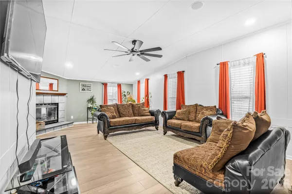 a living room with furniture and a fireplace