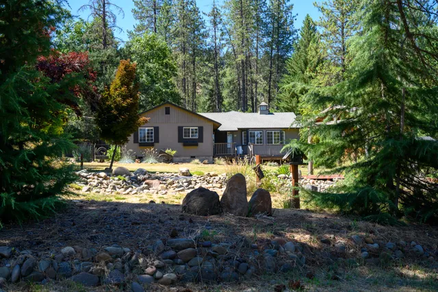 a view of a house with a yard and sitting area