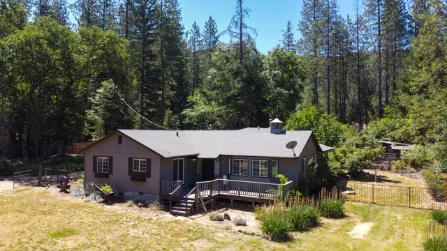 a view of a house with a yard covered with snow in the backyard