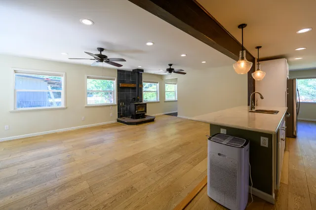 a view of a room with a sink and wooden floor