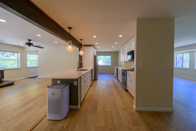 a view of kitchen with cabinets and wooden floor