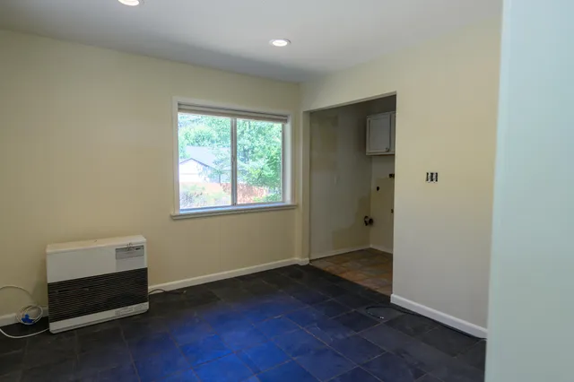 a kitchen with granite countertop a sink a stove and cabinets