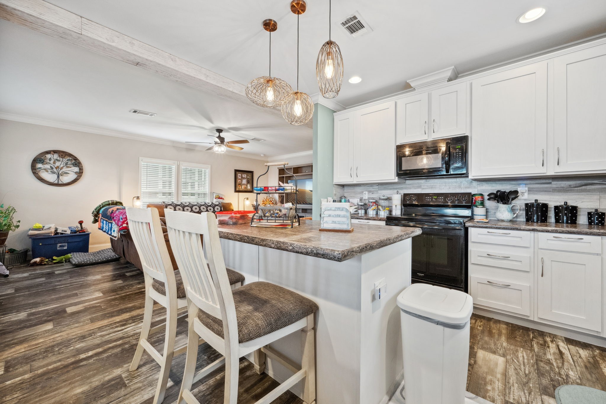 730 Coco Loop Point Blank, TX 77364 - Photo 12 of 42 a kitchen with stainless steel appliances kitchen island granite countertop a table chairs and a refrigerator