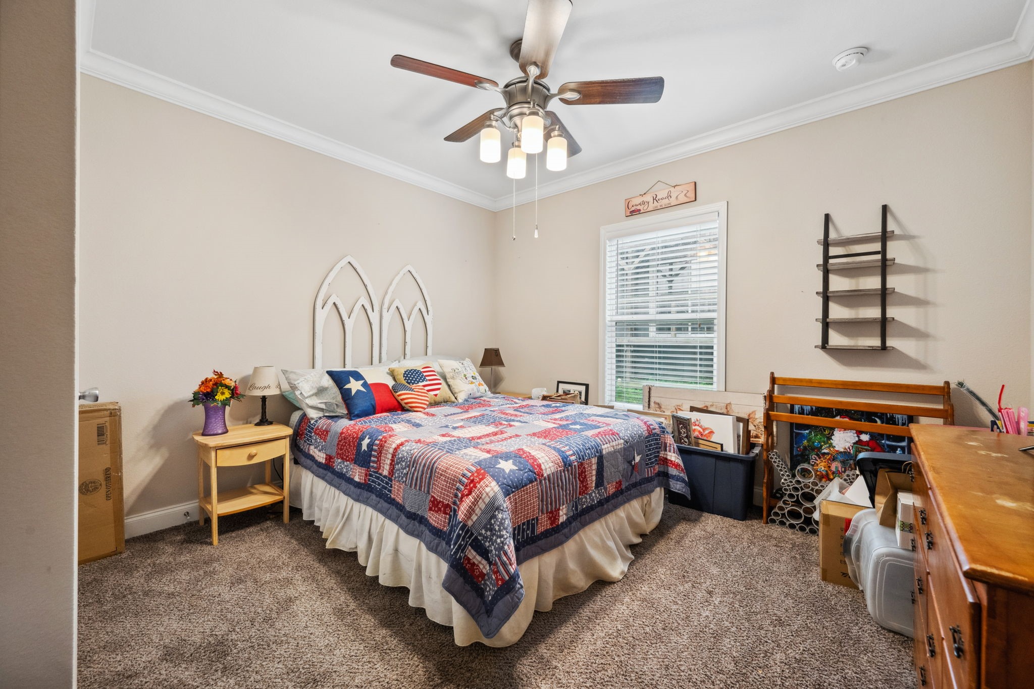 730 Coco Loop Point Blank, TX 77364 - Photo 16 of 42 a bed room with a bed and a chandelier