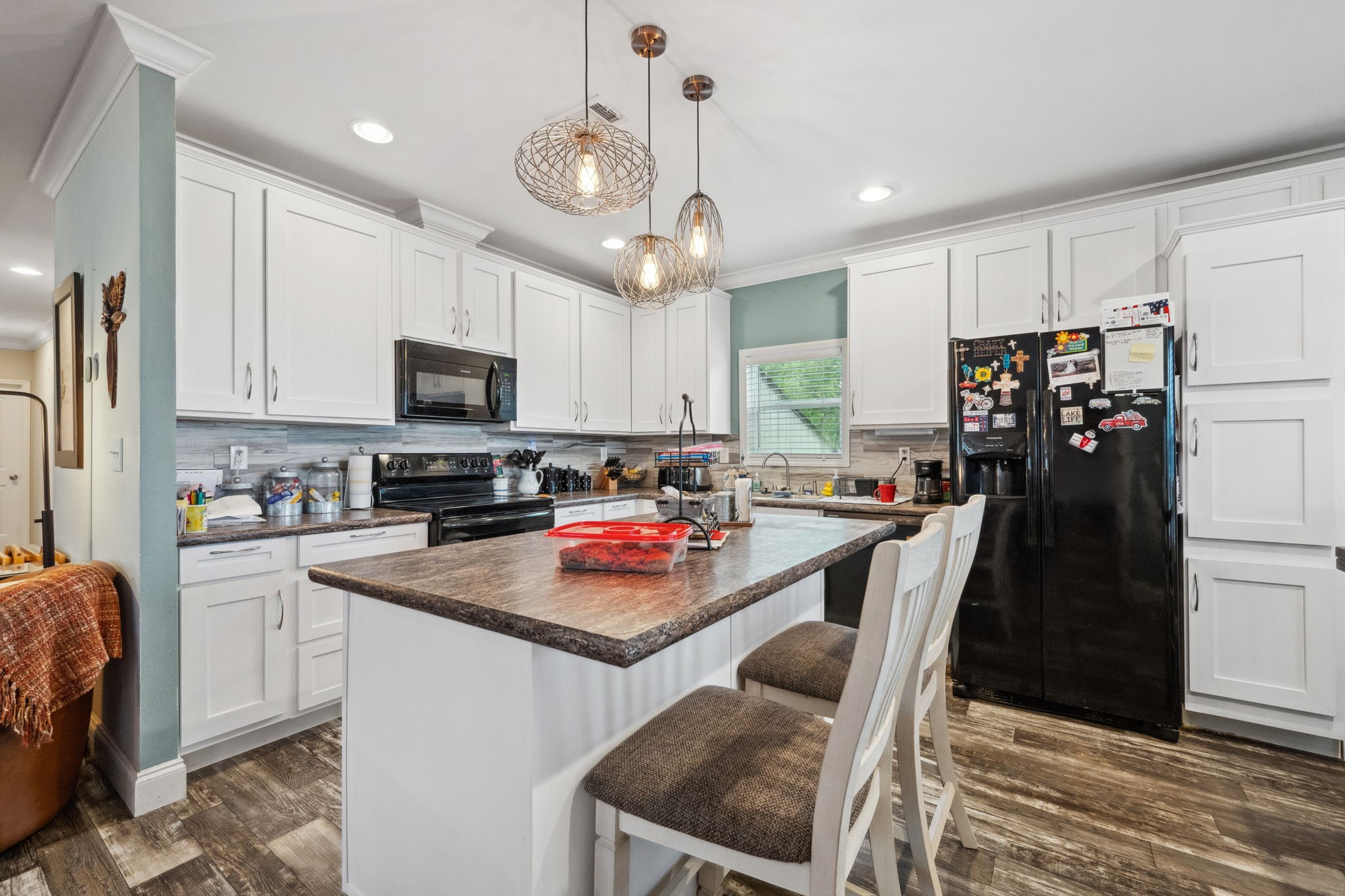 730 Coco Loop Point Blank, TX 77364 - Photo 10 of 42 a kitchen with a refrigerator a stove top oven a sink dishwasher and white cabinets with wooden floor