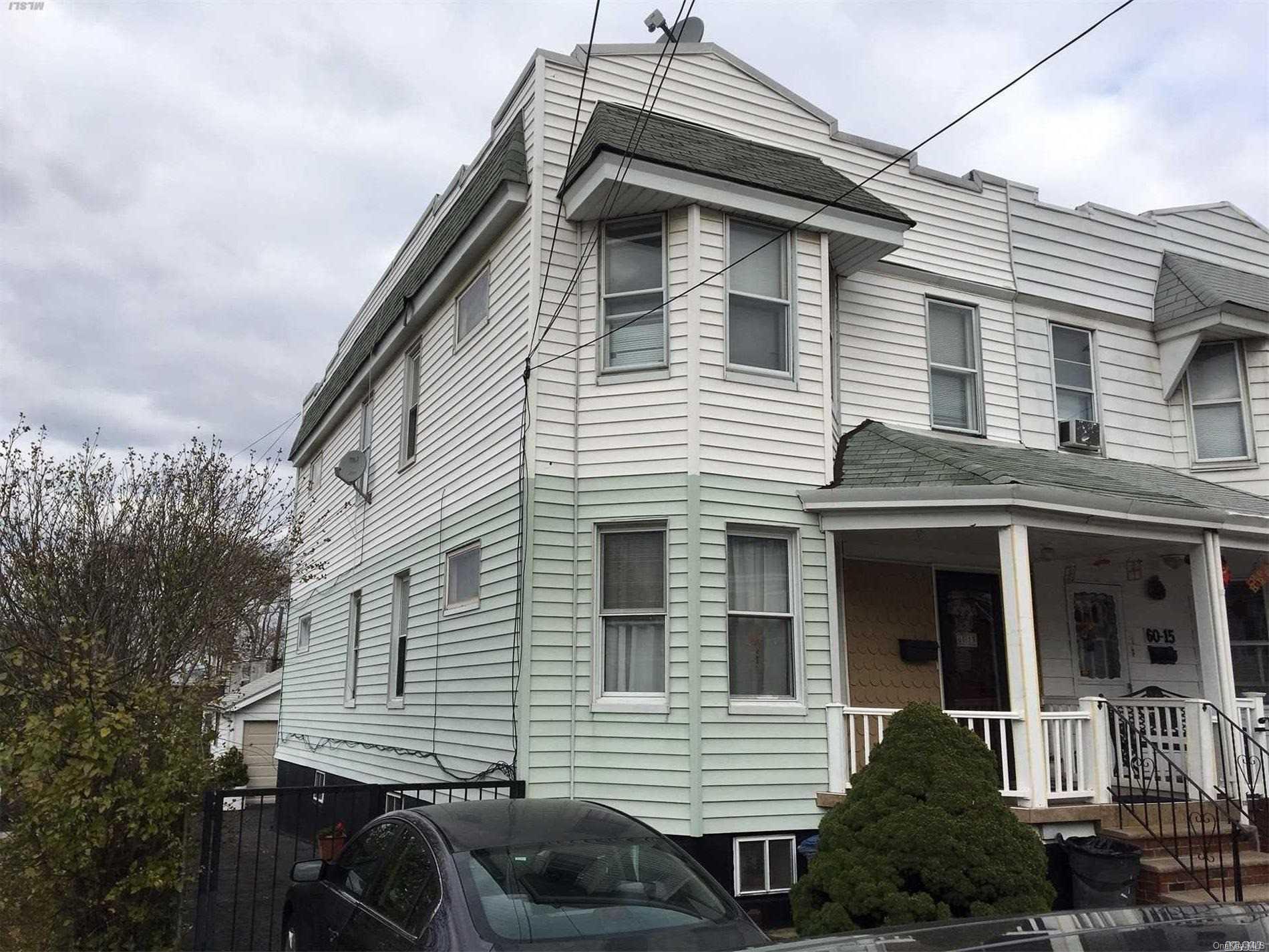 60-13 59th Road Queens, NY 11378 - Photo 1 of 20 a front view of a house with garden