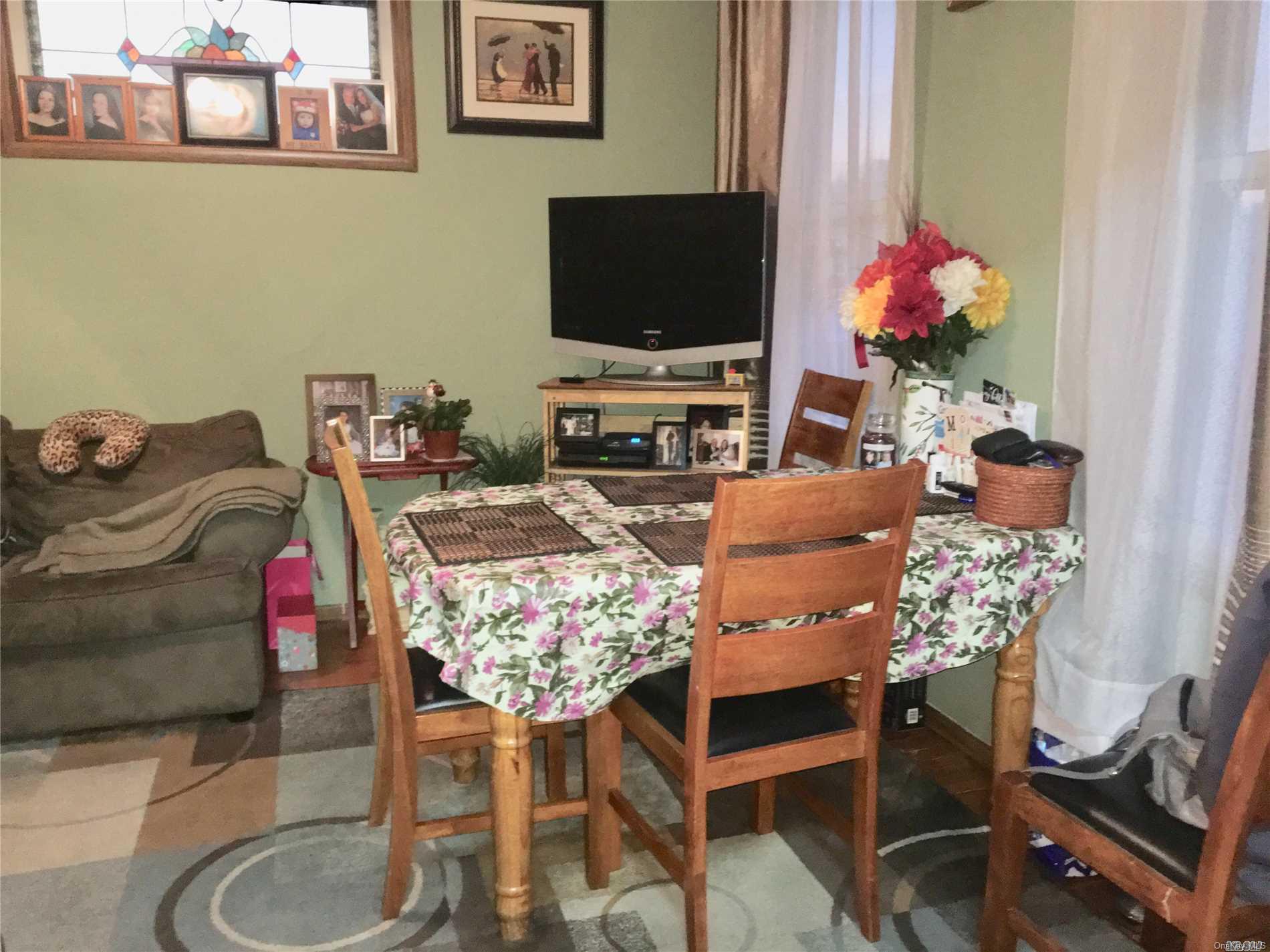 60-13 59th Road Queens, NY 11378 - Photo 11 of 20 a living room with furniture and a flat screen tv