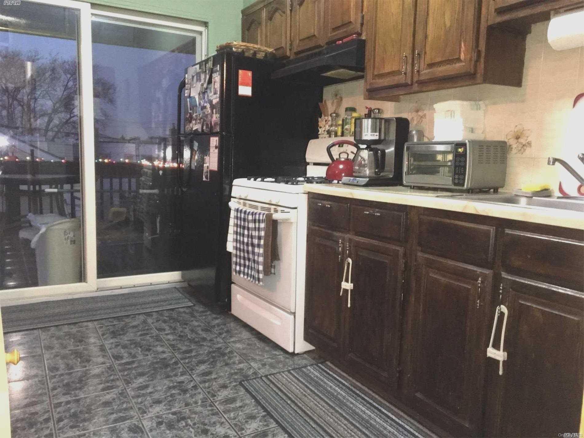 60-13 59th Road Queens, NY 11378 - Photo 12 of 20 a kitchen with granite countertop a sink and cabinets