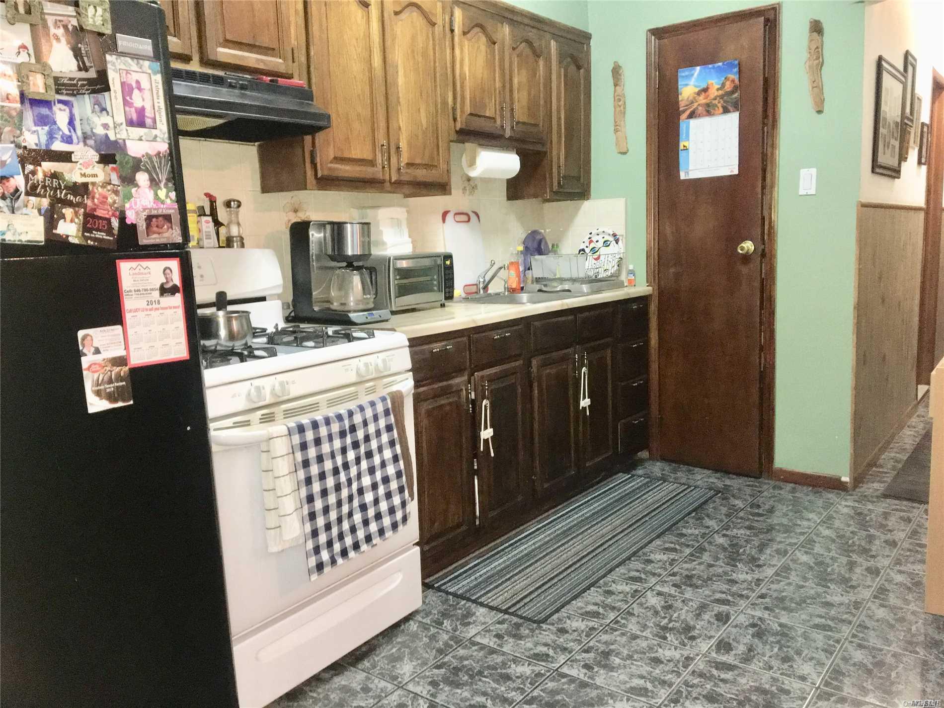 60-13 59th Road Queens, NY 11378 - Photo 13 of 20 a kitchen with a sink and cabinets
