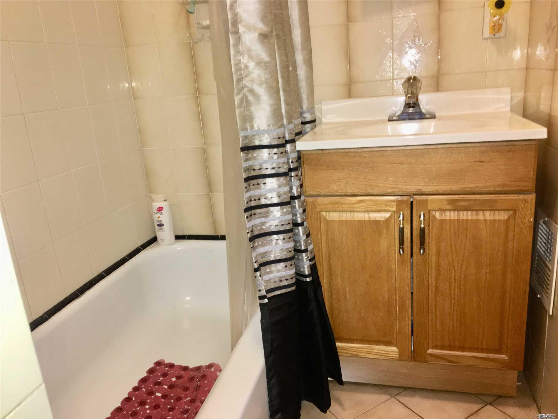 60-13 59th Road Queens, NY 11378 - Photo 15 of 20 a bathroom with a sink and a mirror