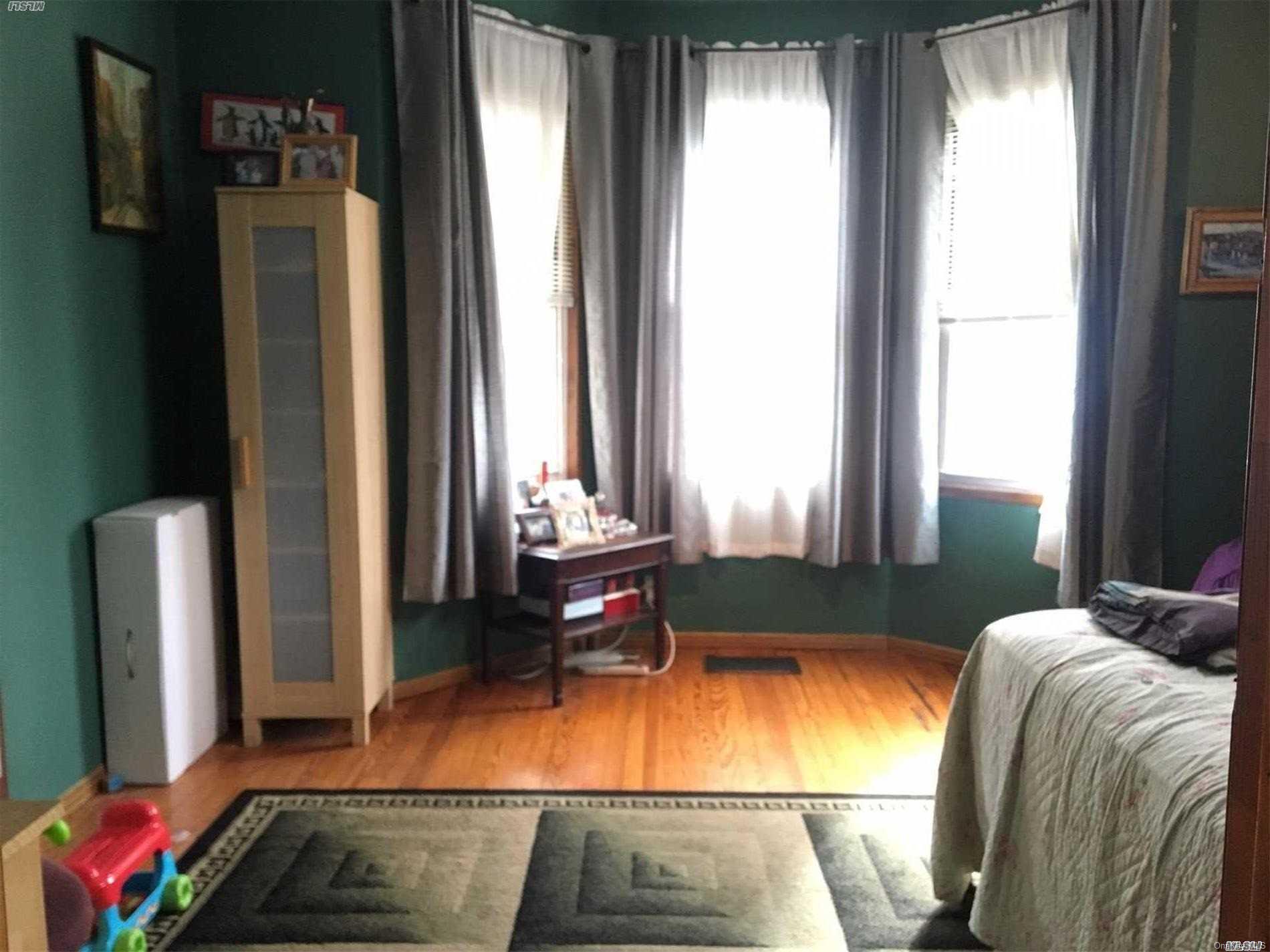 60-13 59th Road Queens, NY 11378 - Photo 17 of 20 a room with furniture and window